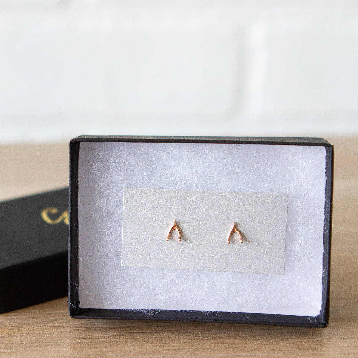 rose gold wishbone stud earrings in a gift box