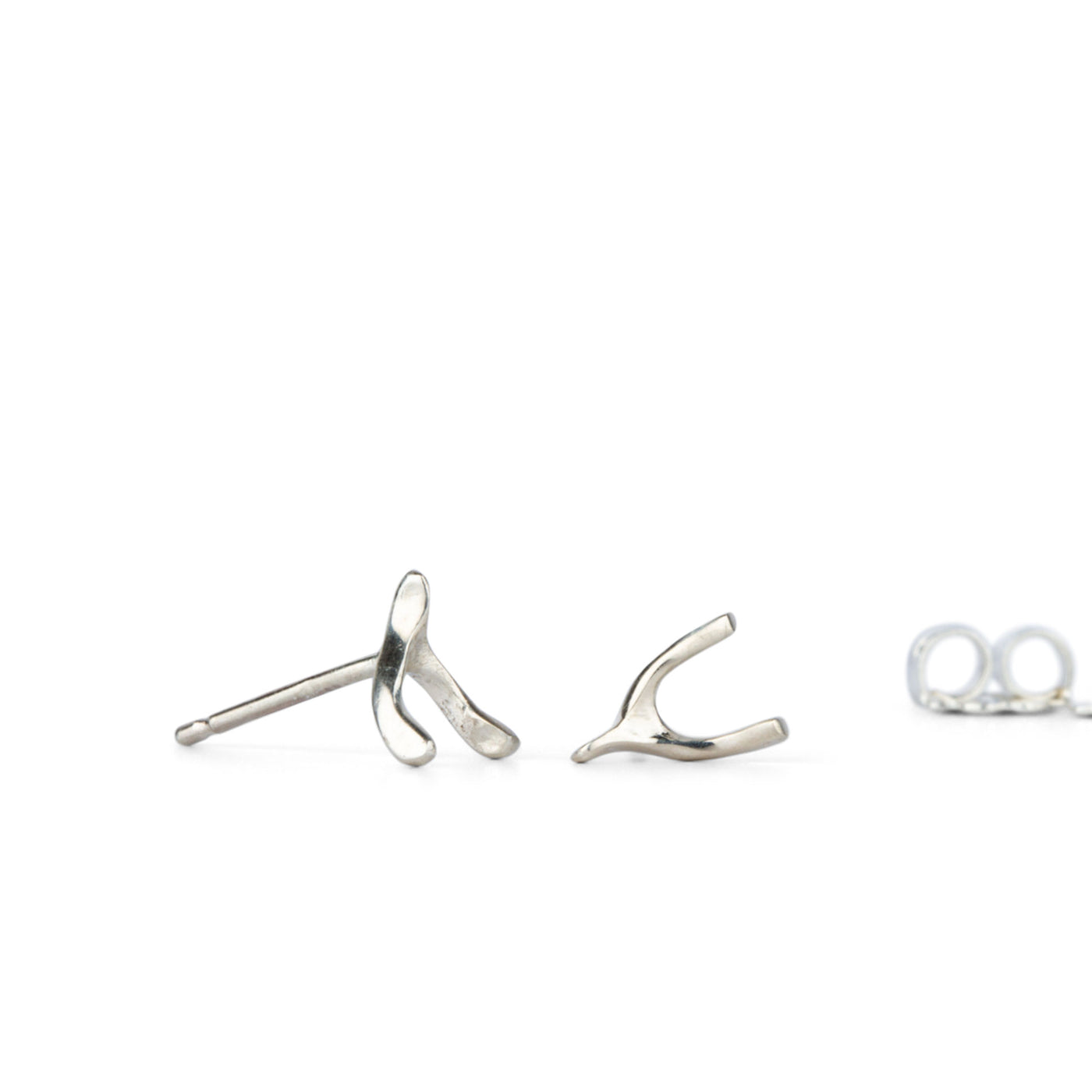 Silver Wishbone Stud Earrings by Corey Egan side view on a white background