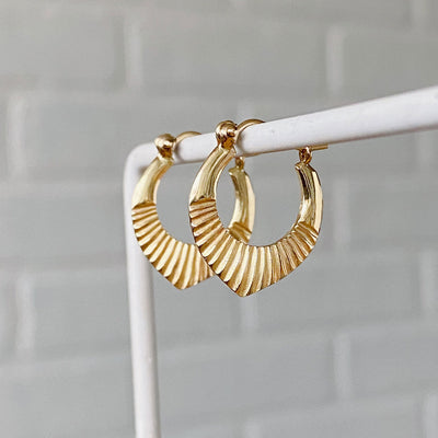 14k yellow gold hinged hoop earrings with carved sunburst motif