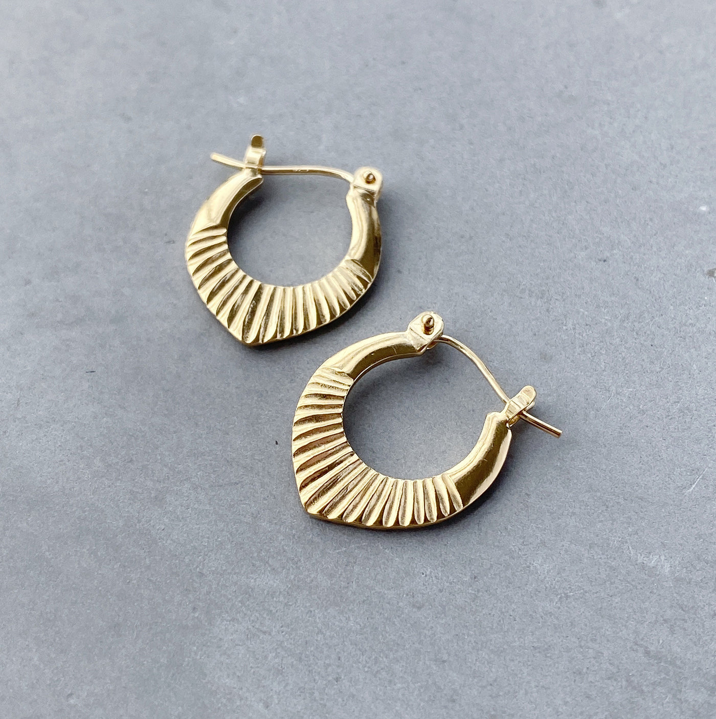 Gold Vermeil Small Oblong hoops with hinge closure and sunburst bottom by Corey Egan