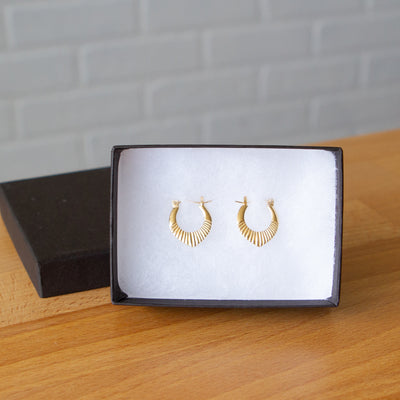 Gold Vermeil Small Oblong hoops with hinge closure and sunburst bottom by Corey Egan in a gift box