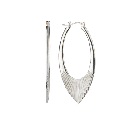 Large Silver Oblong hoops with hinge closure and sunburst bottom by Corey Egan side view on a white background