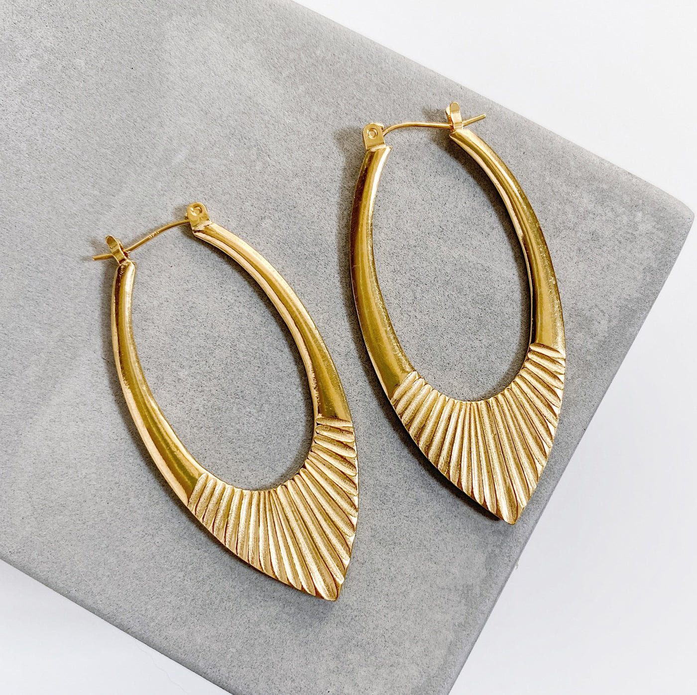 Gold Vermeil Large Oblong hoops with hinge closure and sunburst bottom by Corey Egan