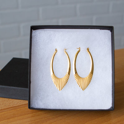 Gold Vermeil Large Oblong hoops with hinge closure and sunburst bottom by Corey Egan in a gift box