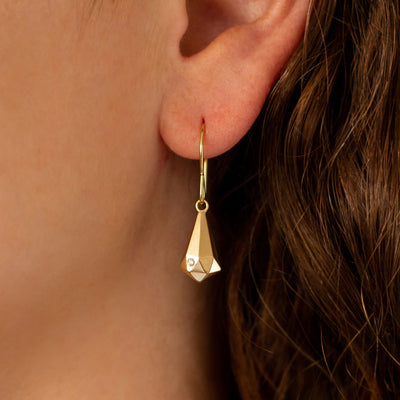Gold and Diamond Faceted Drop Dangle Earrings  on an ear