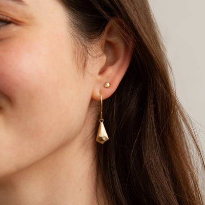 Gold and Diamond Crystal Fragment Earrings modeled on an ear