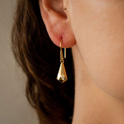 Gold Vermeil and Diamond Faceted Drop Dangle Earrings on an ear