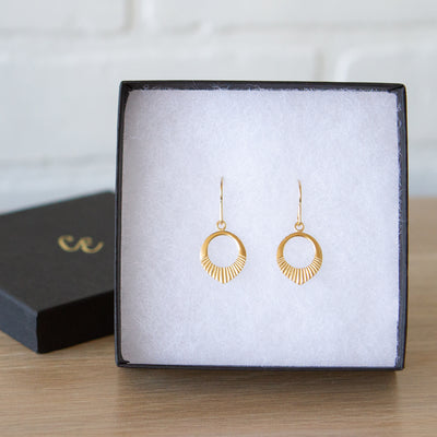 Gold vermeil small open petal shape earrings with sunburst bottoms in a gift box