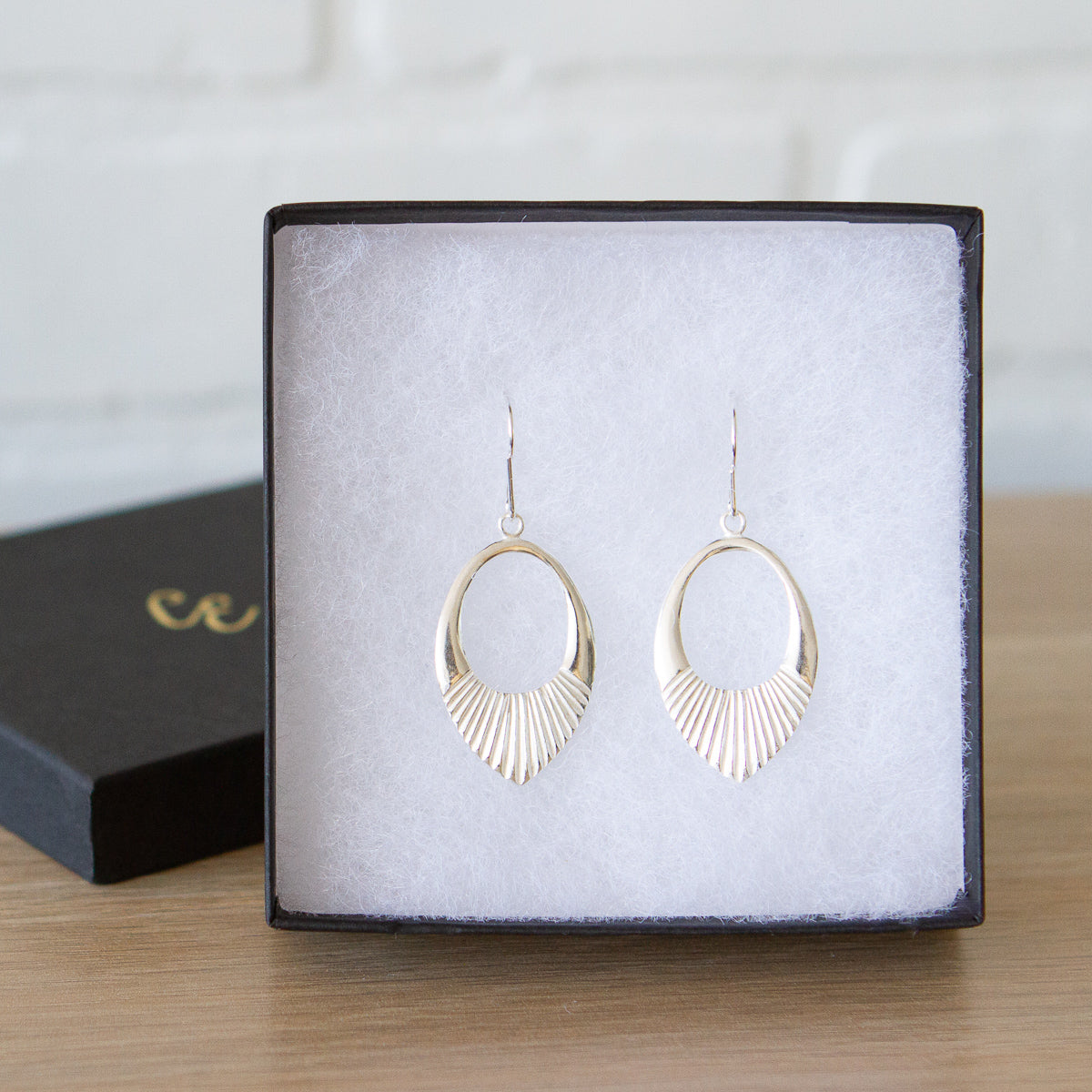 Silver Medium open petal shape earrings with textured bottoms in a gift box