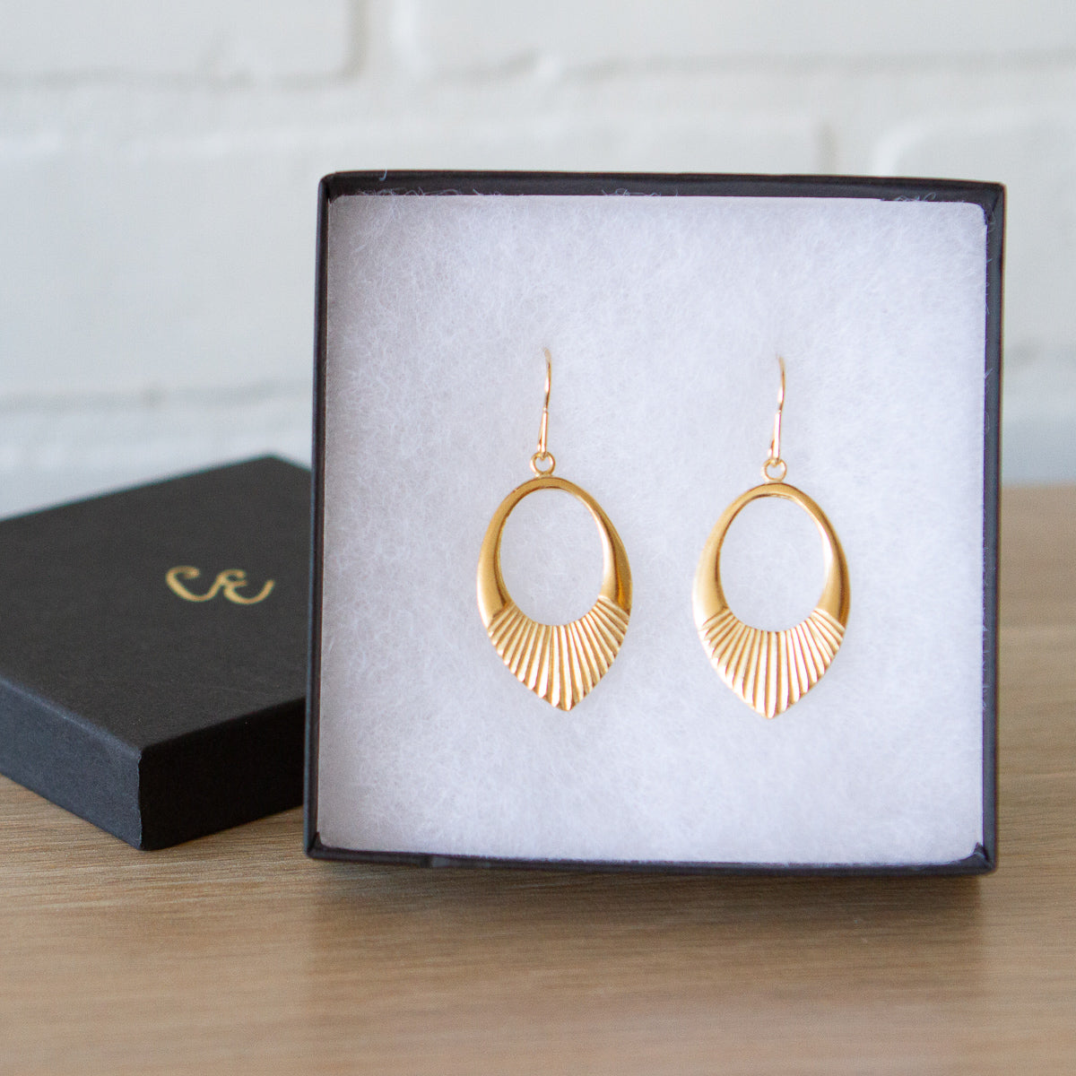 Gold vermeil medium open petal shape earrings with textured bottoms in a gift box
