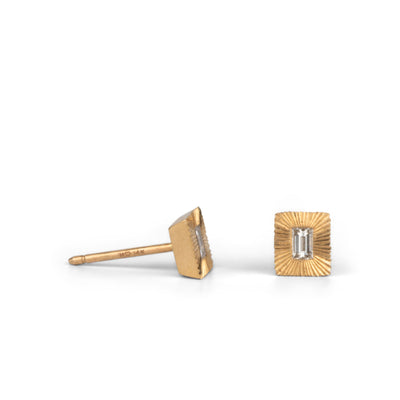 Side view #2 Rectangle 14k yellow gold Aurora stud earrings with baguette diamond centers and engraved rays on a white background
