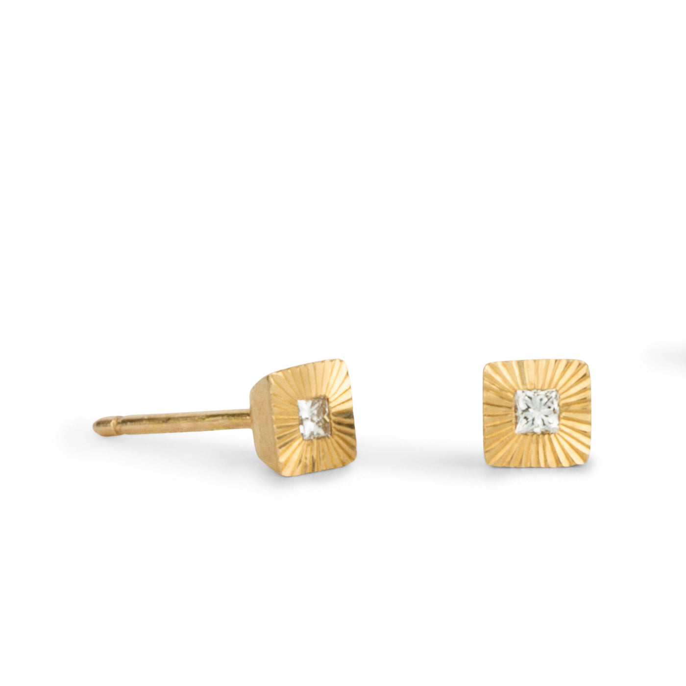 Square 14k yellow gold Aurora stud earrings with princess cut diamond centers and engraved rays side view on a white background