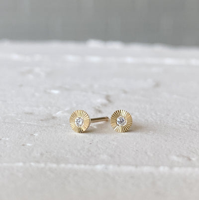 14k yellow gold micro aurora stud earrings with diamond centers and an engraved halo border in natural light alternate view