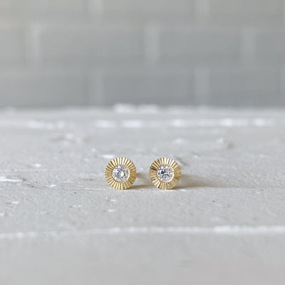 14k yellow gold small engraved Aurora stud earrings with white diamond centers in natural light