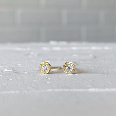 14k yellow gold small engraved Aurora stud earrings with white diamond centers in natural light alternate view