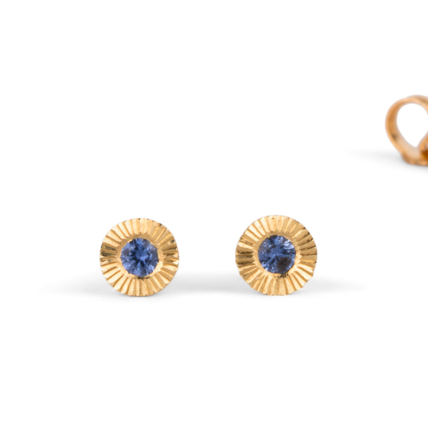 14k yellow gold small engraved Aurora stud earrings with blue Yogo Montana Sapphires on a white background