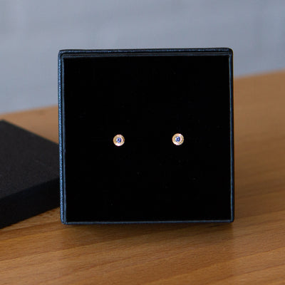14k yellow gold small engraved Aurora stud earrings with blue Yogo Montana Sapphires in a gift box