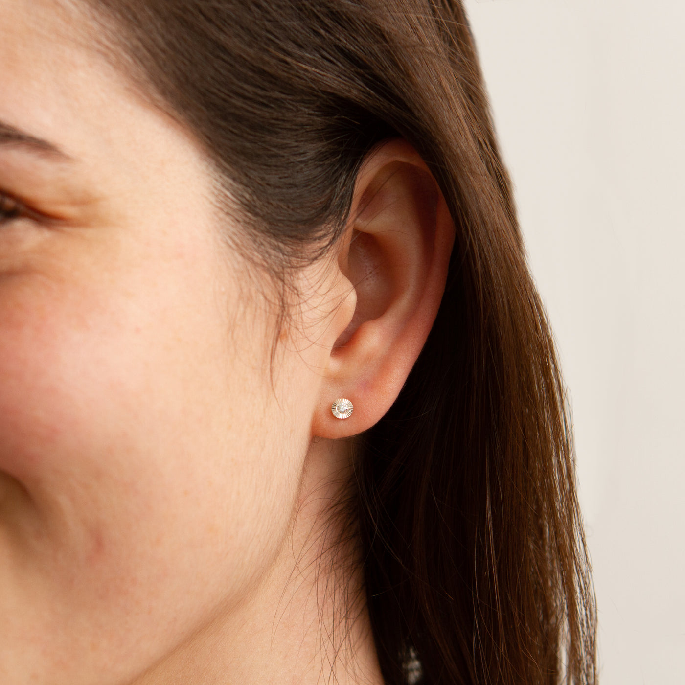 Small Aurora Diamond Stud Earring in Sterling Silver modeled on an ear