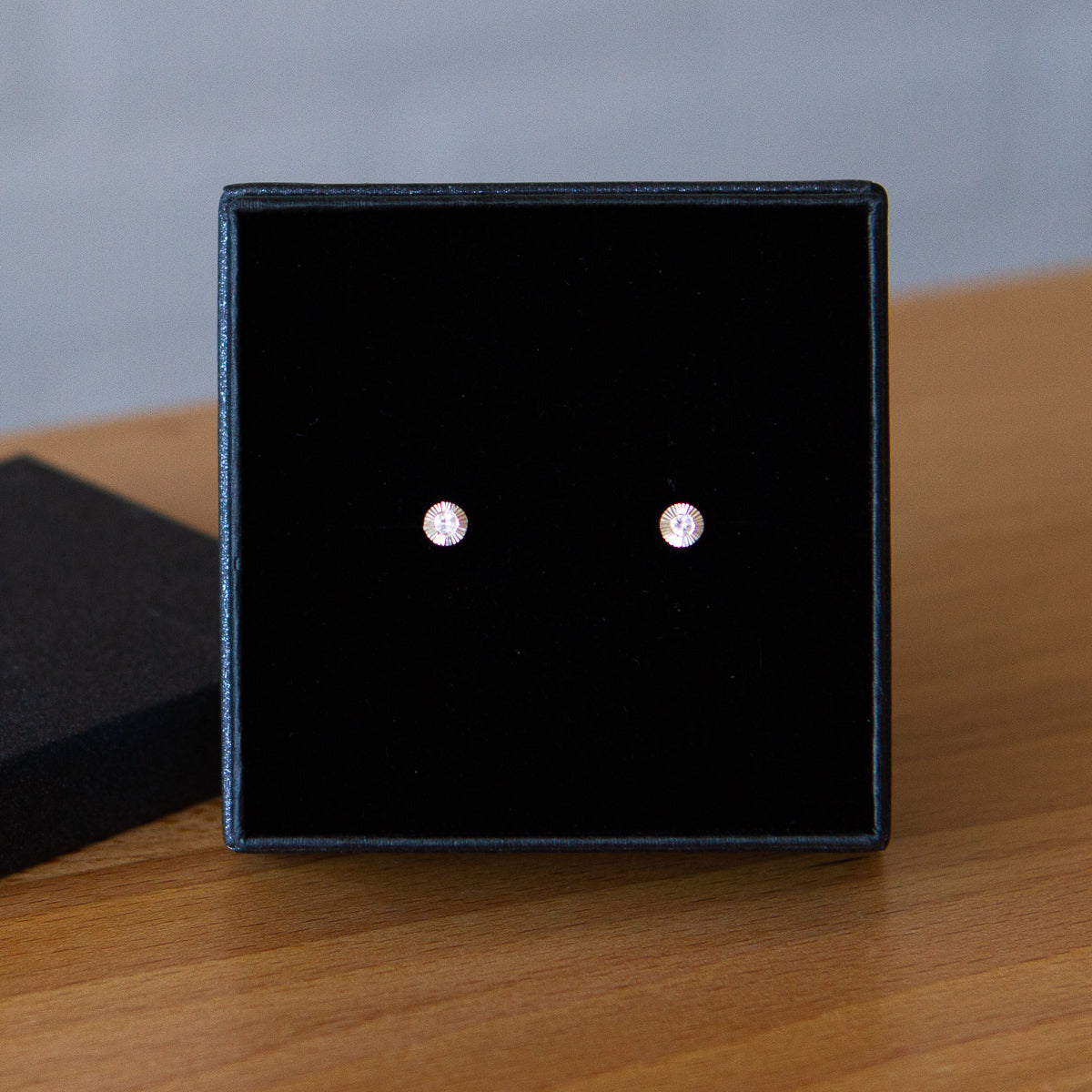Sterling silver small engraved Aurora stud earrings with moonstone centers in a gift box