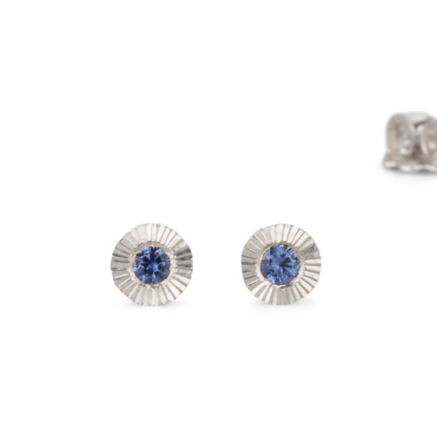 Sterling silver small engraved Aurora stud earrings with blue Yogo Montana Sapphires on a white background