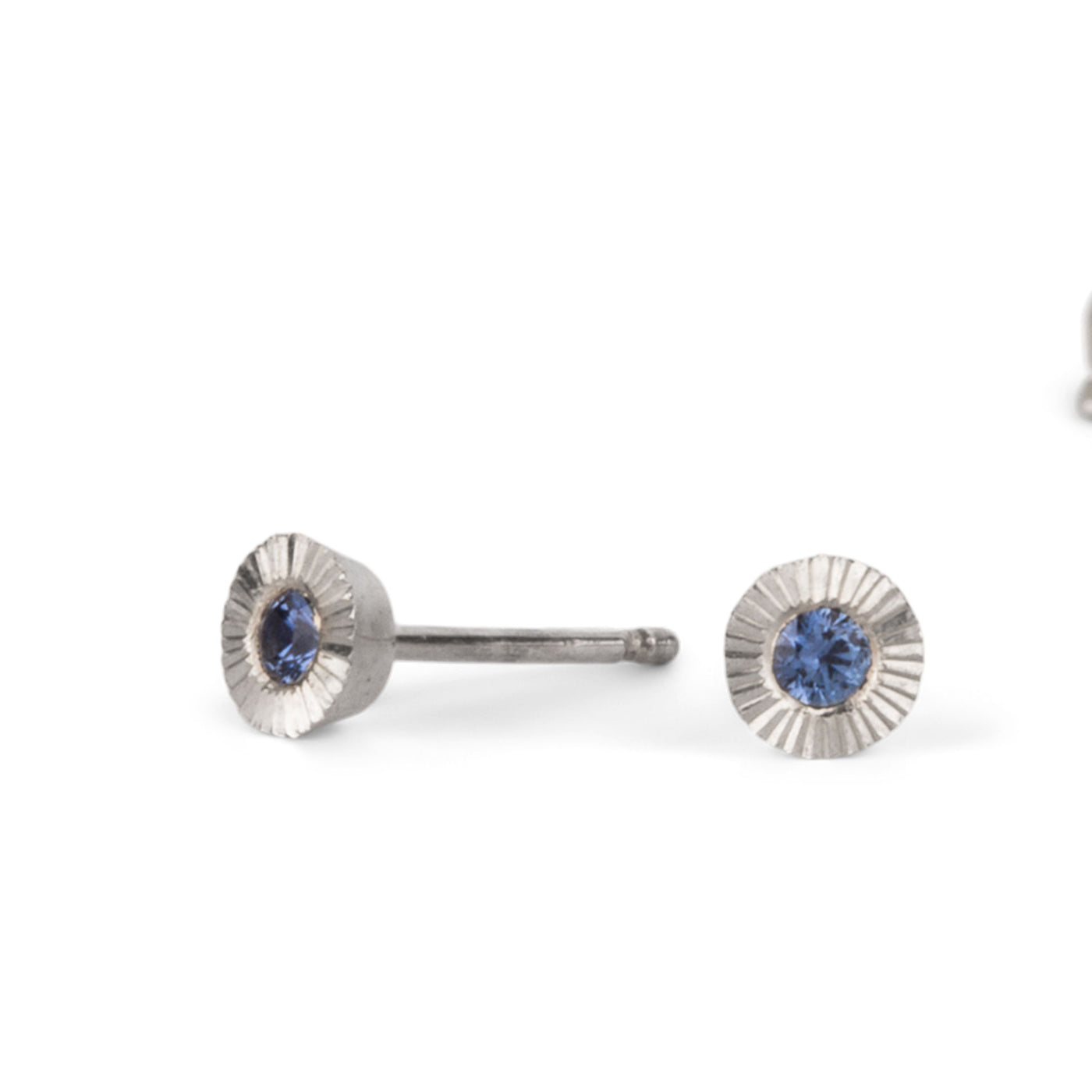 Sterling silver small engraved Aurora stud earrings with blue Yogo Montana Sapphires on a white background