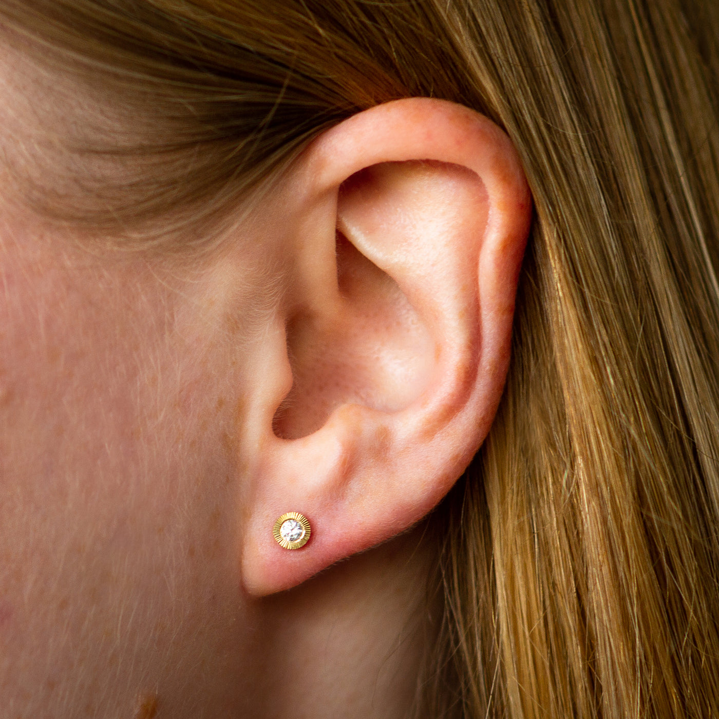 Medium Aurora Diamond Stud Earring in Yellow Gold on an ear