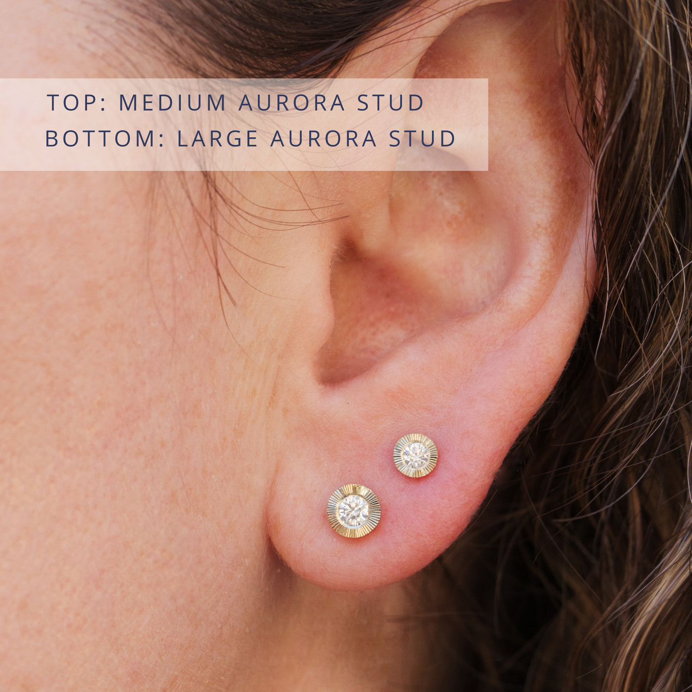 Aurora stud earrings on an ear. Top: Small yellow gold Aurora stud earring with a diamond center, bottom: Large yellow gold Aurora stud earring with diamond center