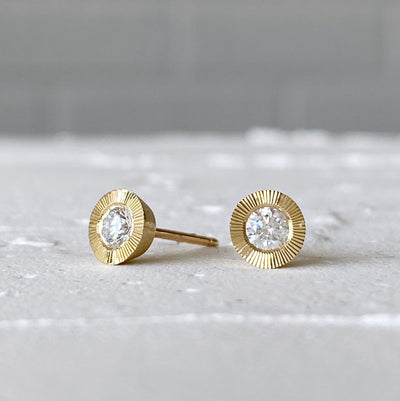 Large Diamond Aurora stud earring in yellow gold with an engraved halo border in natural light alternate view