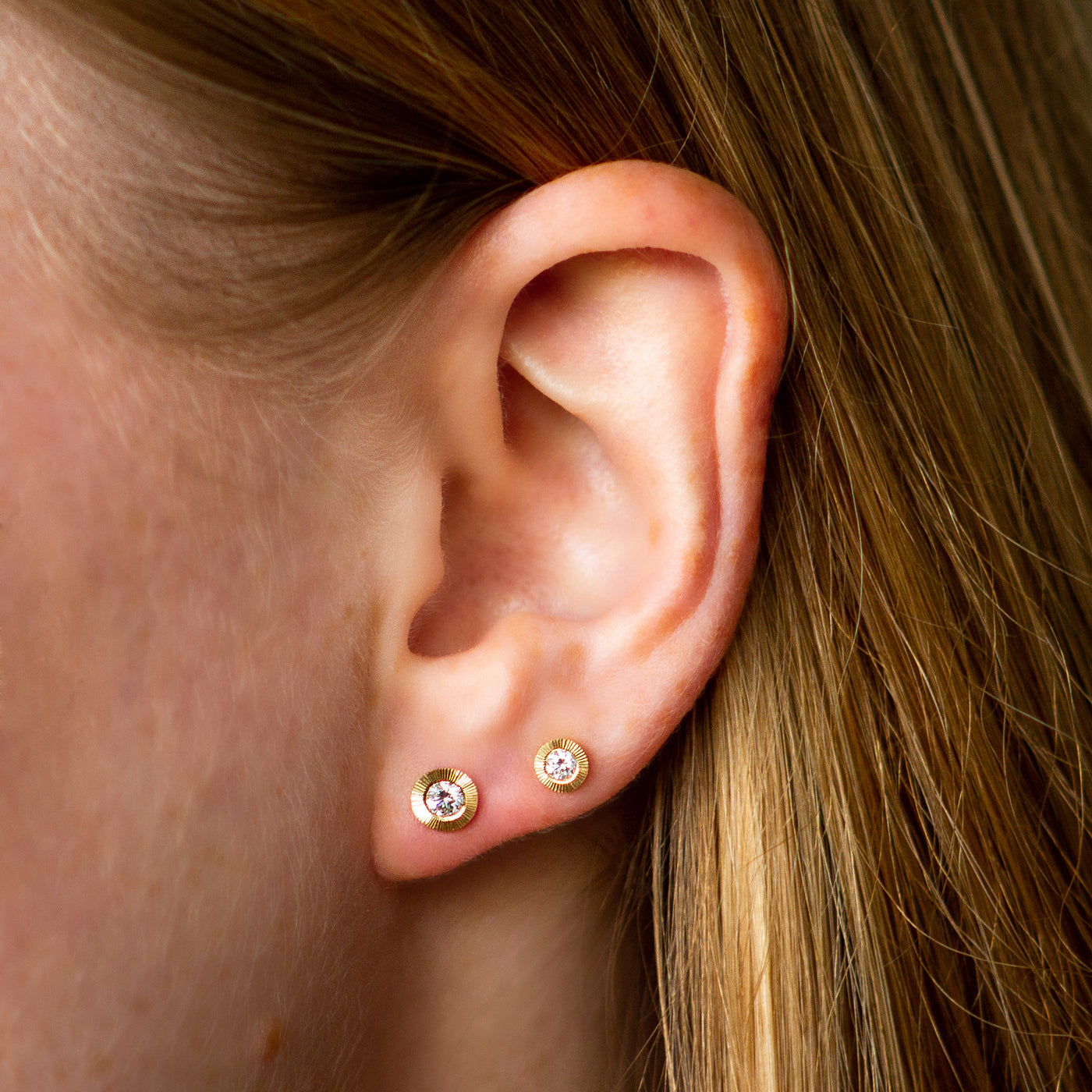 Large Aurora Diamond Stud Earring vs Medium Aurora Diamond Stud Earring in Yellow Gold on an ear