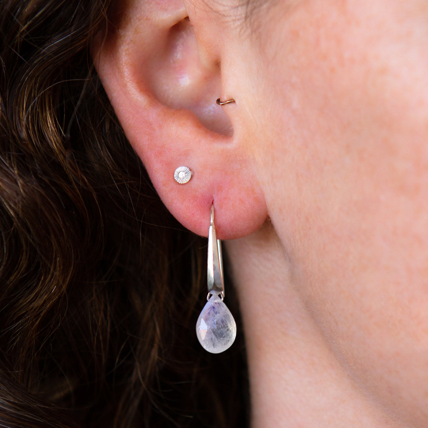 sterling silver fragment dangle earrings with moonstone drops on an ear