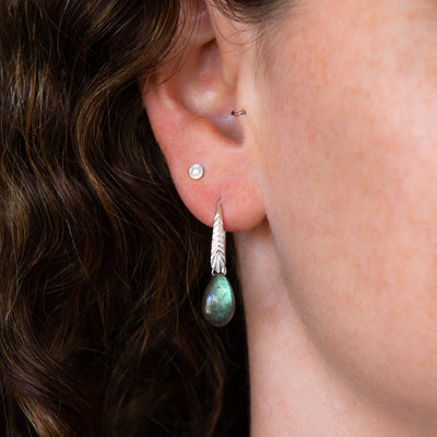 sterling silver Herringbone dangle earrings with pear shape smooth labradorite drops on an ear