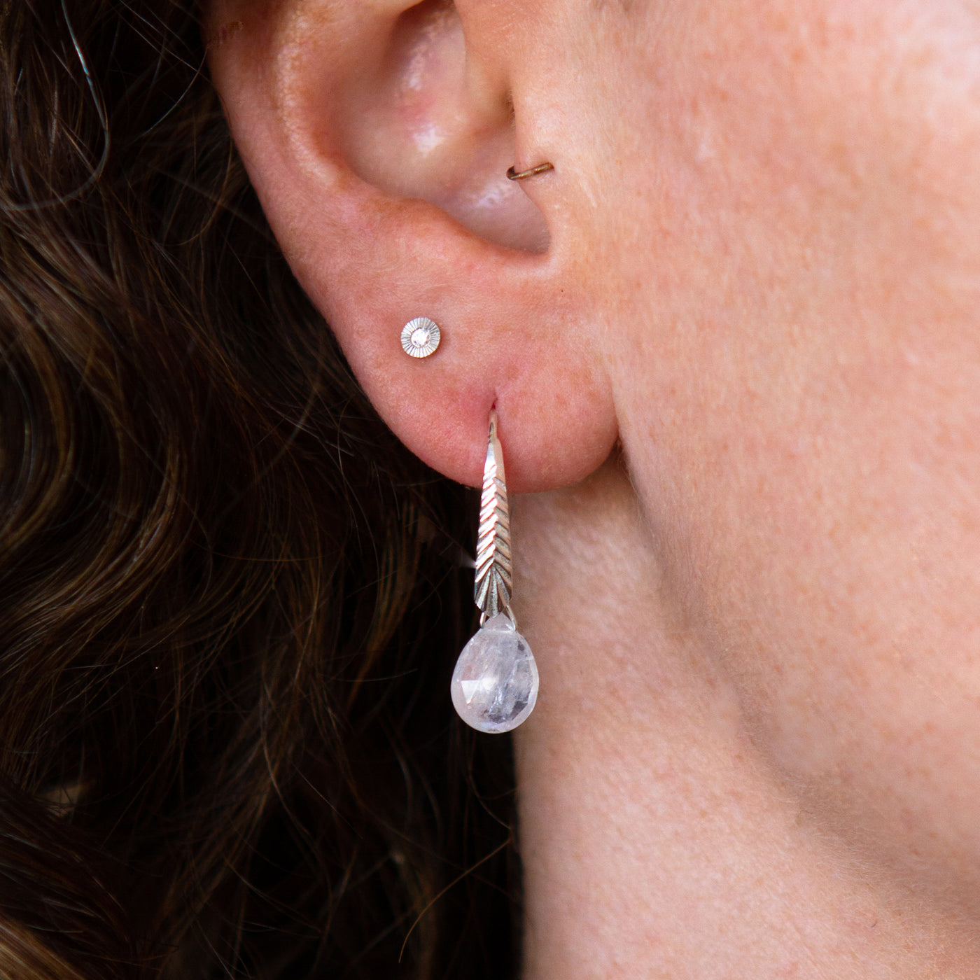 sterling silver Herringbone dangle earrings with pear shape moonstone drops on an ear