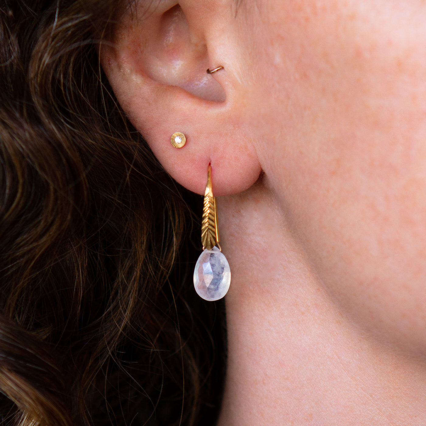 Vermeil Herringbone dangle earrings with pear shape moonstone drops on an ear