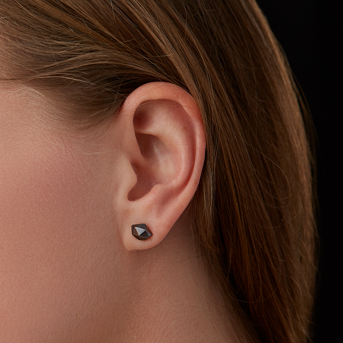 Oxidized Silver Tiny Fragment Stud Earrings faceted stud earrings on an ear
