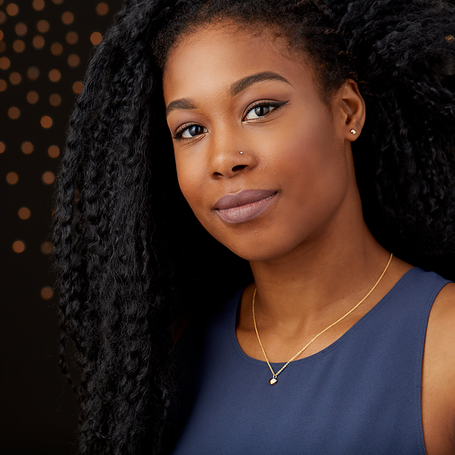 Faceted geometric gold tiny fragment necklace with a single white diamond in one facet on a model | Corey Egan