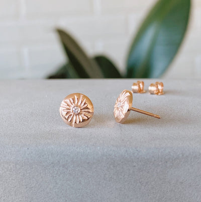 14k rose gold lucia stud earrings with white diamond centers side view