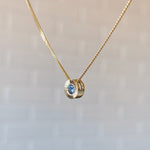 14k yellow gold small aurora necklace with a blue montana sapphire center side view