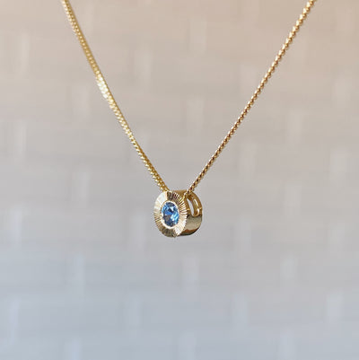 14k yellow gold small aurora necklace with a blue montana sapphire center side view