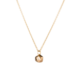 Faceted geometric gold tiny fragment necklace with a single white diamond in one facet side view on a white background | Corey Egan