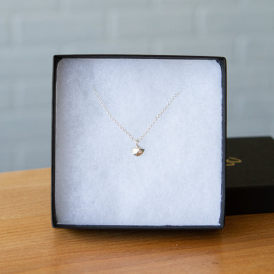Sterling silver wabi-sabi faceted geometric necklace with a single diamond facet by Corey Egan in a gift box