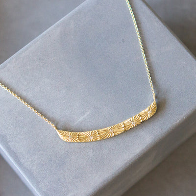 14k yellow gold Luminous bar necklace with five carved sunbursts and five scattered white diamonds
