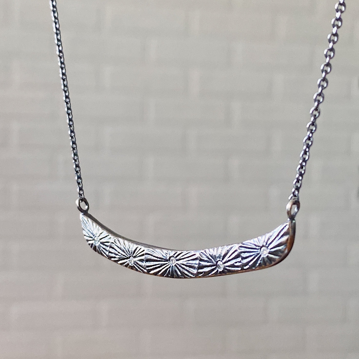 Oxidized Silver Luminous Bar Necklace by Corey Egan side view in daylight