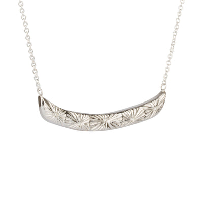 Sterling silver curved bar necklace with five scattered diamonds and an engraved sunburst pattern radiating from each on a white background | Corey Egan