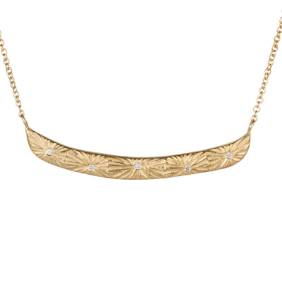 Curved bar necklace with five scattered diamonds and carved sunburst motif on a white background by Corey Egan