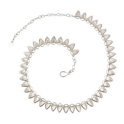 Sterling silver statement necklace made of triangular carved links with a sunburst design | Corey Egan