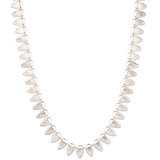 Sterling silver statement necklace made of triangular carved links with a sunburst design on a white background alternate view | Corey Egan