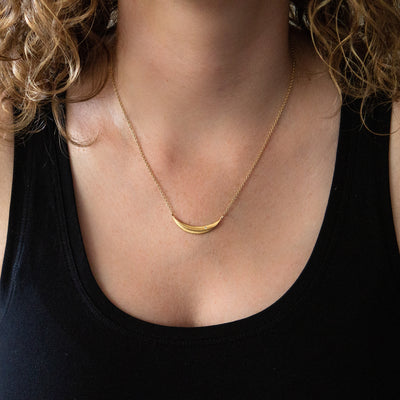 Wisp Diamond Vermeil Necklace around a neck by Corey Egan