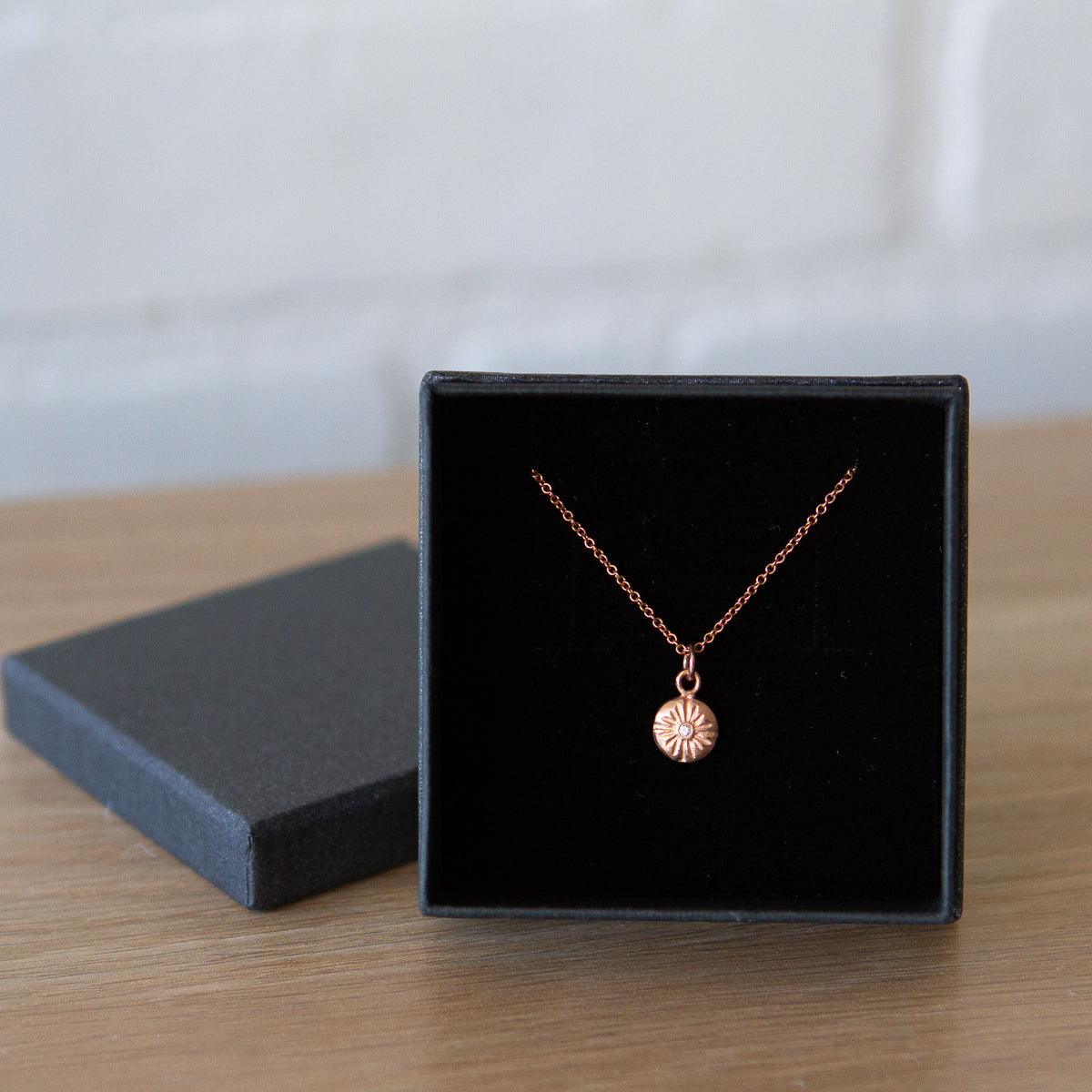 Rose Gold Sunburst Lucia Necklace with Diamond by Corey Egan in a gift box