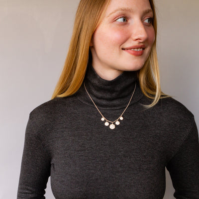 Five Lucia Diamond Silver Necklace on a model wearing a turtleneck  | Corey Egan