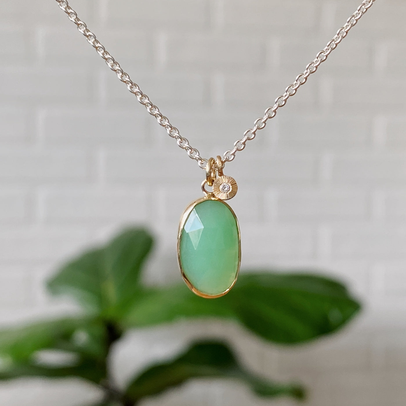 Long oval rose cut chrysoprase in yellow gold bezel pendant paired with a yellow gold engraved diamond pendant on a silver chain.